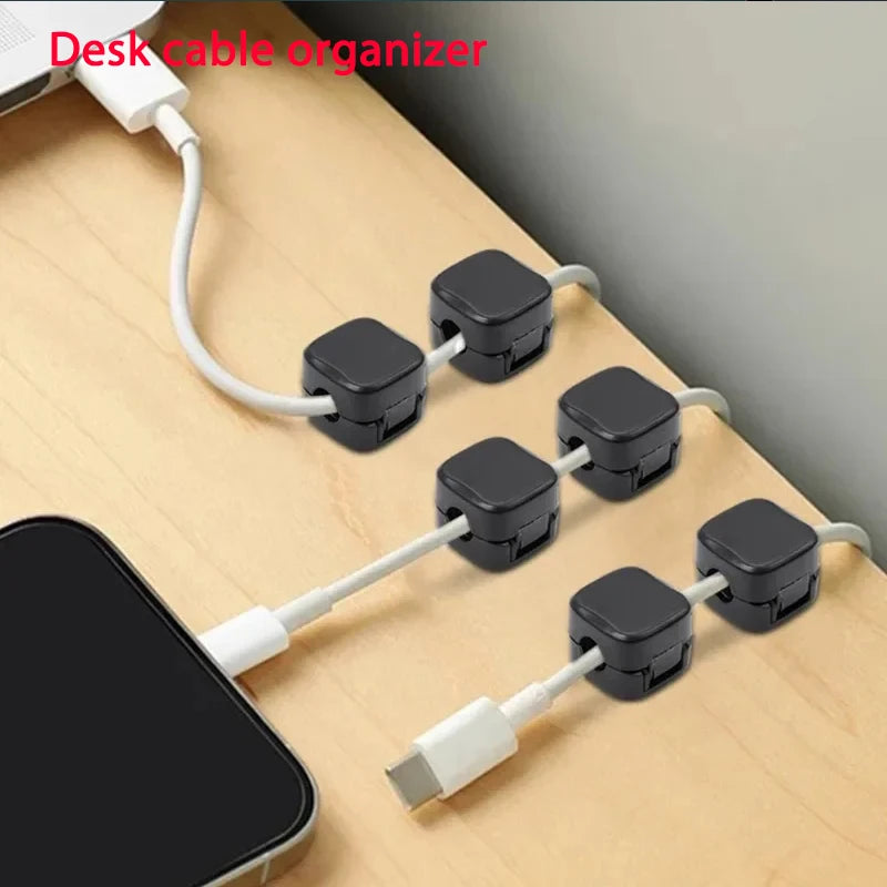 Black magnetic cable clips holding multiple charging cables neatly arranged on a wooden desk for home office organization using Magnetic Cable Clip Cable Holder Adhesive Wire Keeper Cord Cable Organizer for Home Office Under Desk Management