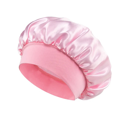 Women Satin Bonnet Hair Bonnet for Sleeping Hair Care Silk Bonnets Solid Wide-brimmed Sleeping Hat with Elastic Soft Band in soft pink satin material for gentle hair protection during sleep.