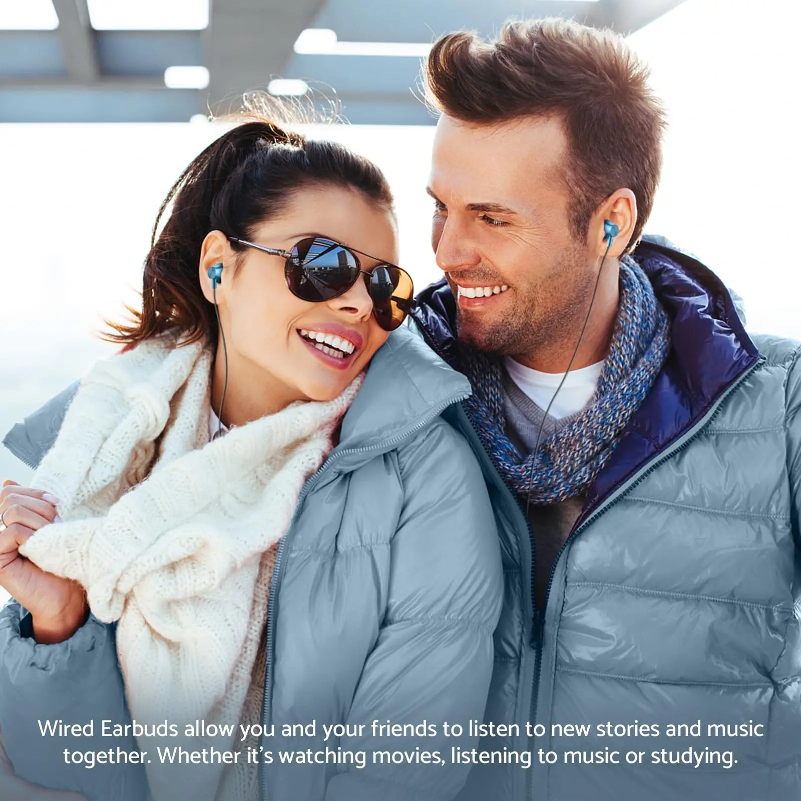A happy couple wearing blue wired earplugs outdoors, showcasing For Samsung Headphones HiFi Surround Sound In-ear USB Type C 3.5mm With wire control Wired Earplugs For Galaxy S24 S23 S22 Ultra with clear sound quality during winter activities.