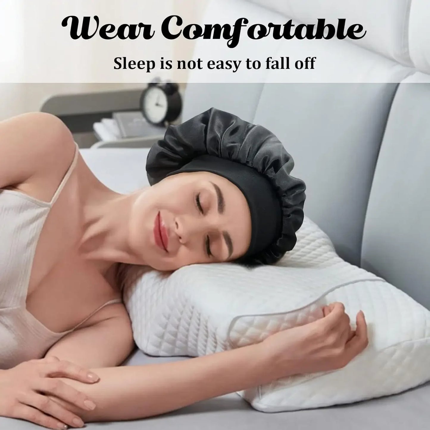 Woman peacefully sleeping on a pillow wearing a black Women Satin Bonnet Hair Bonnet for Sleeping Hair Care Silk Bonnets Solid Wide-brimmed Sleeping Hat with Elastic Soft Band in a cozy bedroom setting.